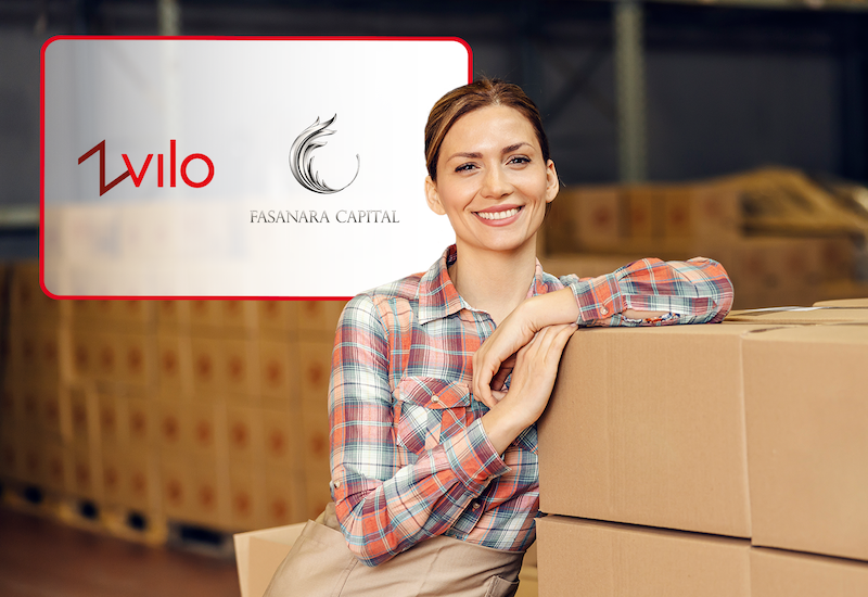 Smiling woman in warehouse facility. Zvilo logo. Fasanara Capital logo.